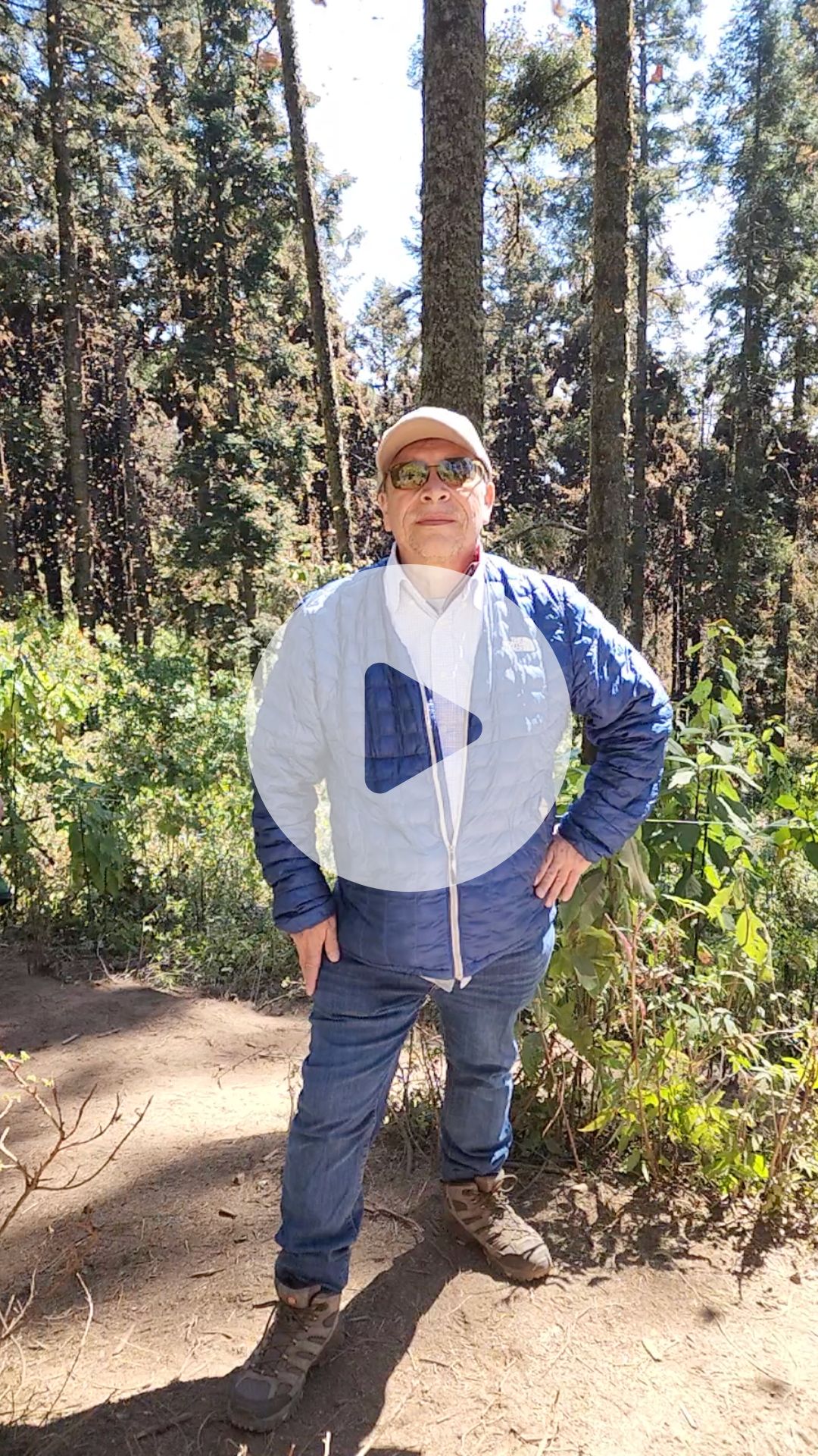 David Mota-Sanchez standing with monarch butterflies flying around him