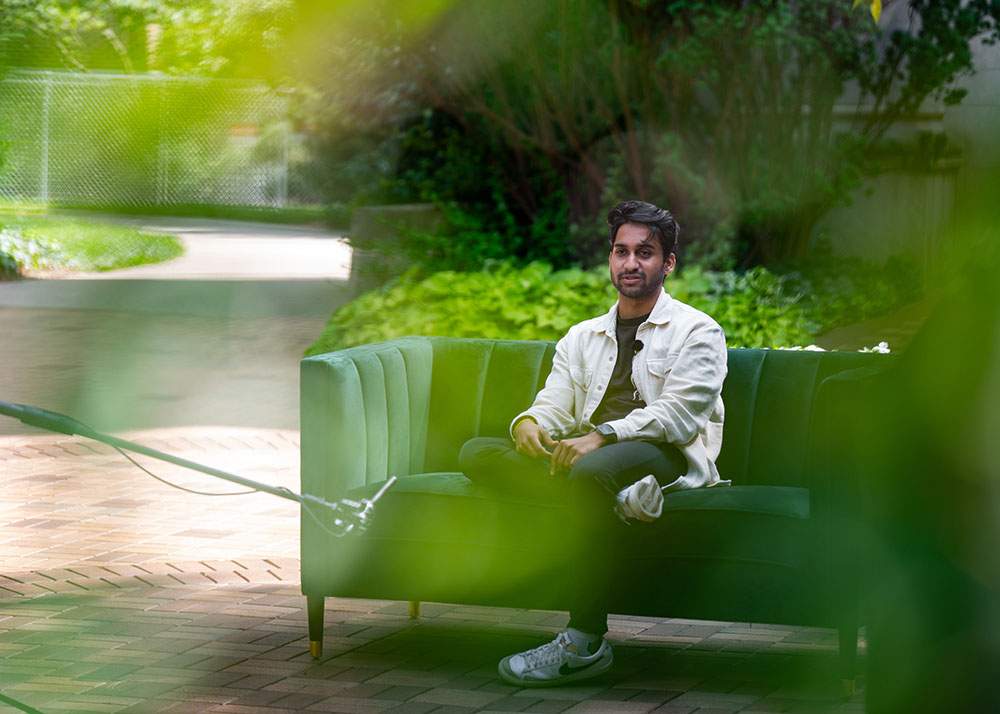 Person sitting on green couch