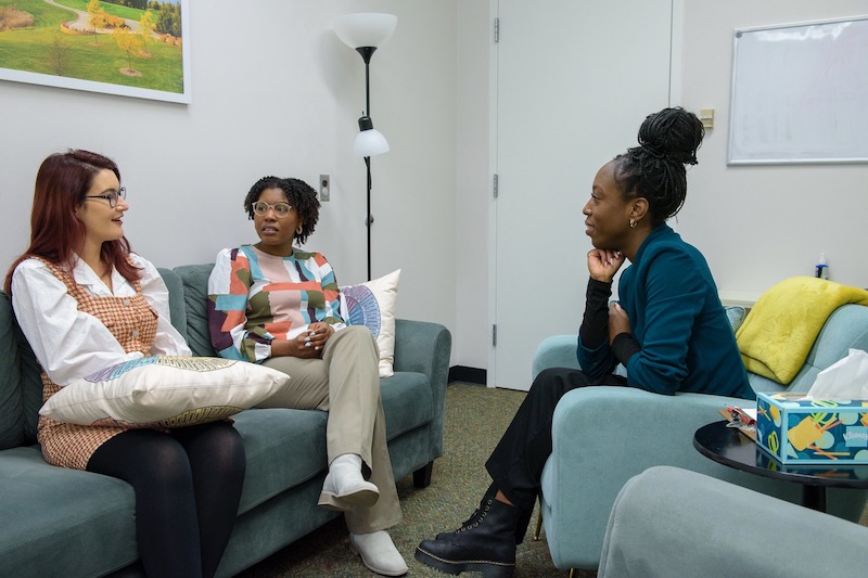 Lekie Dwanyen (right) hosts a supervision meeting with CFT student therapists.