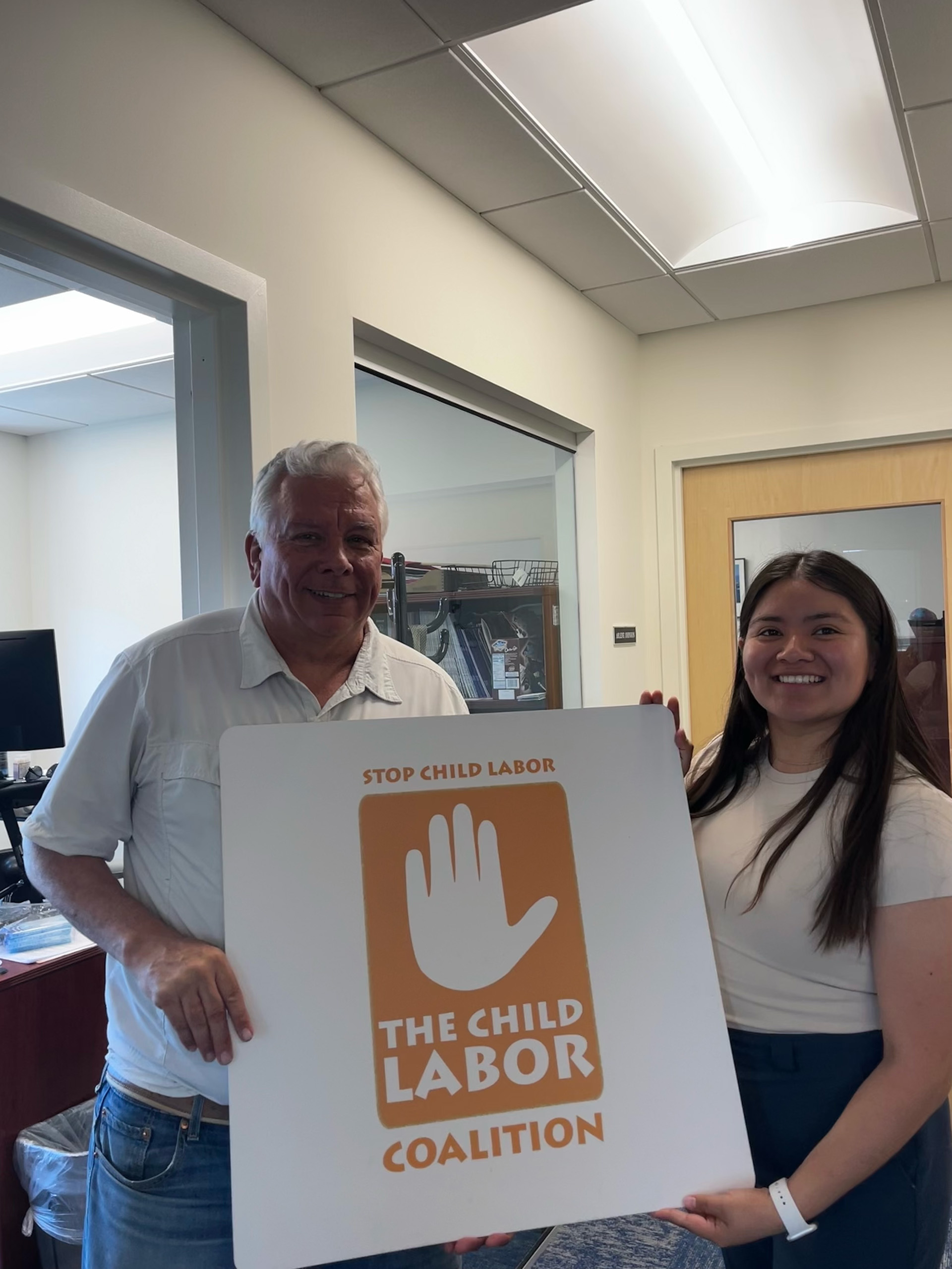 Luz Vazquez holding a stop child labor coalition sign