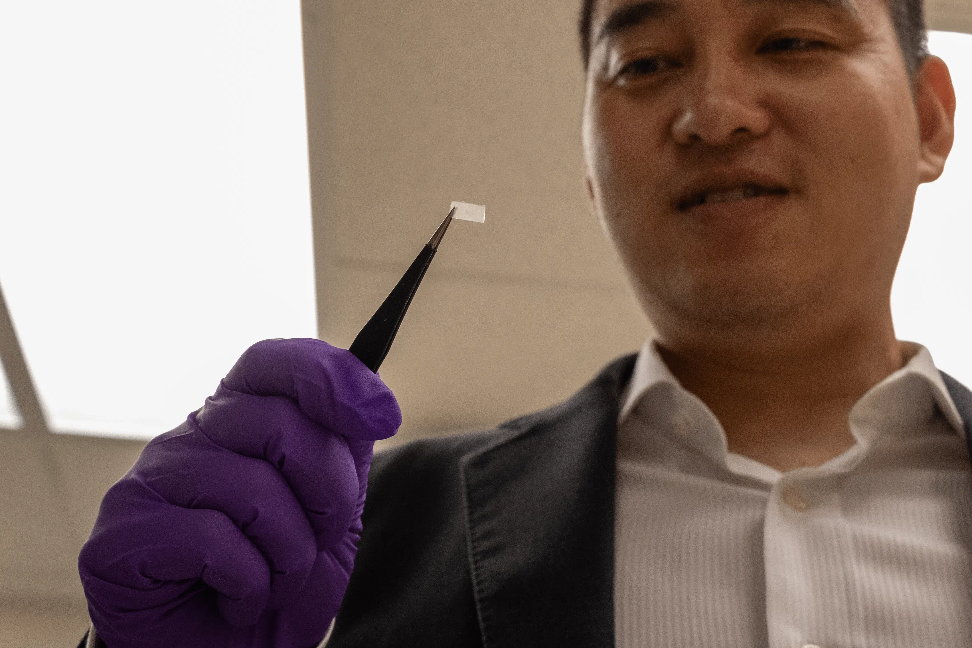 Shaoting Lin holds a polymeric thermal switch.