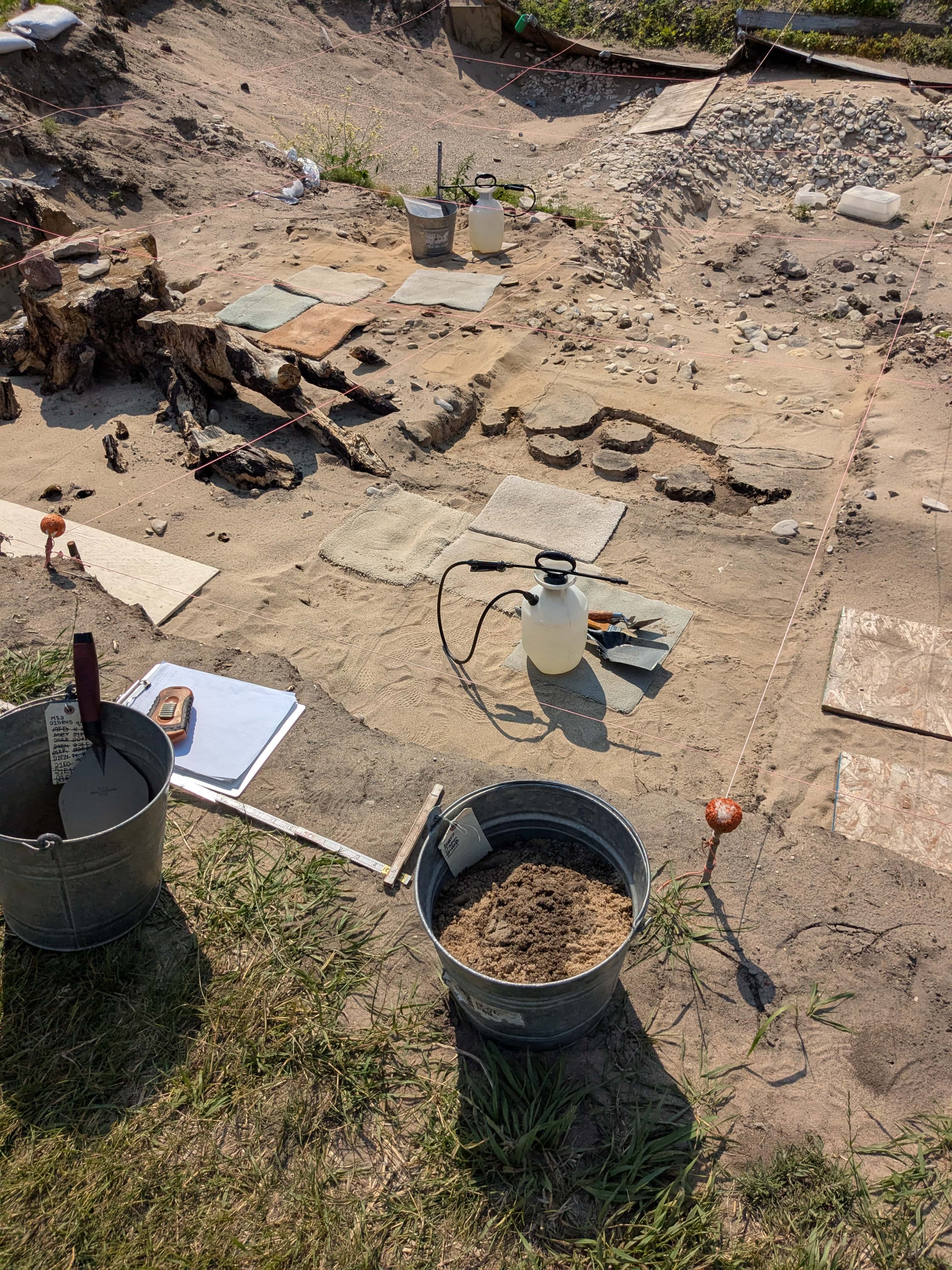 Sullivan’s tools include water sprayers and trowels of various sizes to delicately remove dirt around artifacts. Photo courtesy of Kelly Sullivan.